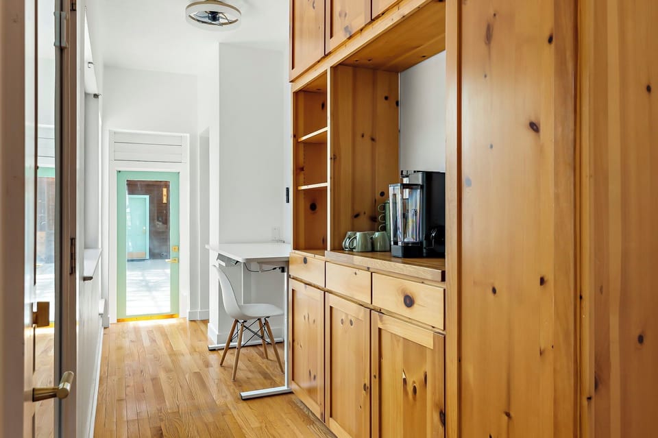 Our cozy coffee corner! Where every sip feels like a warm hug. With these lovely wooden cabinets, I can store all my favorite brews and accessories in style!
