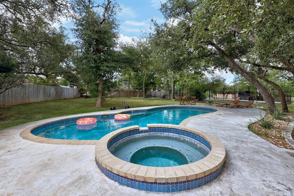 Dive into fun with this awesome pool and hot tub setup.