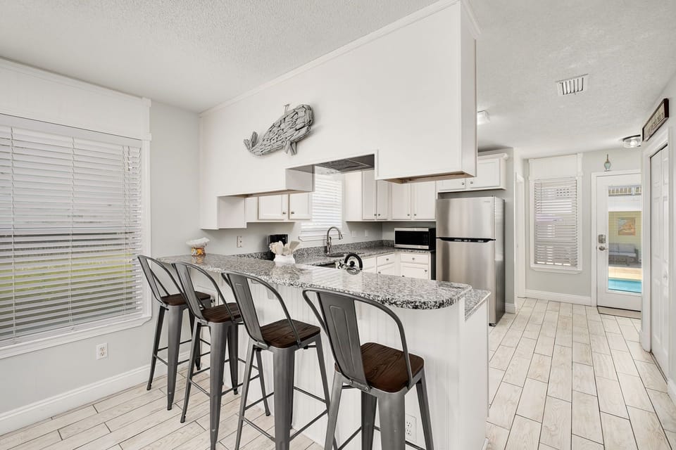 The counter-height bar can comfortably seat 4 guests.