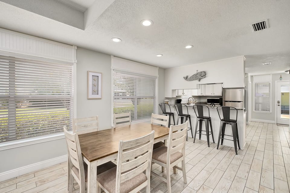 The dining room offers abundant lighting and seating for 6.