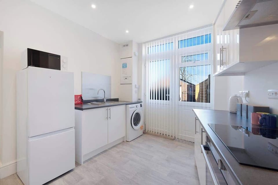 Kitchen equipped with all essentials, including a washer & dryer, oven, fridge and full cookware set.