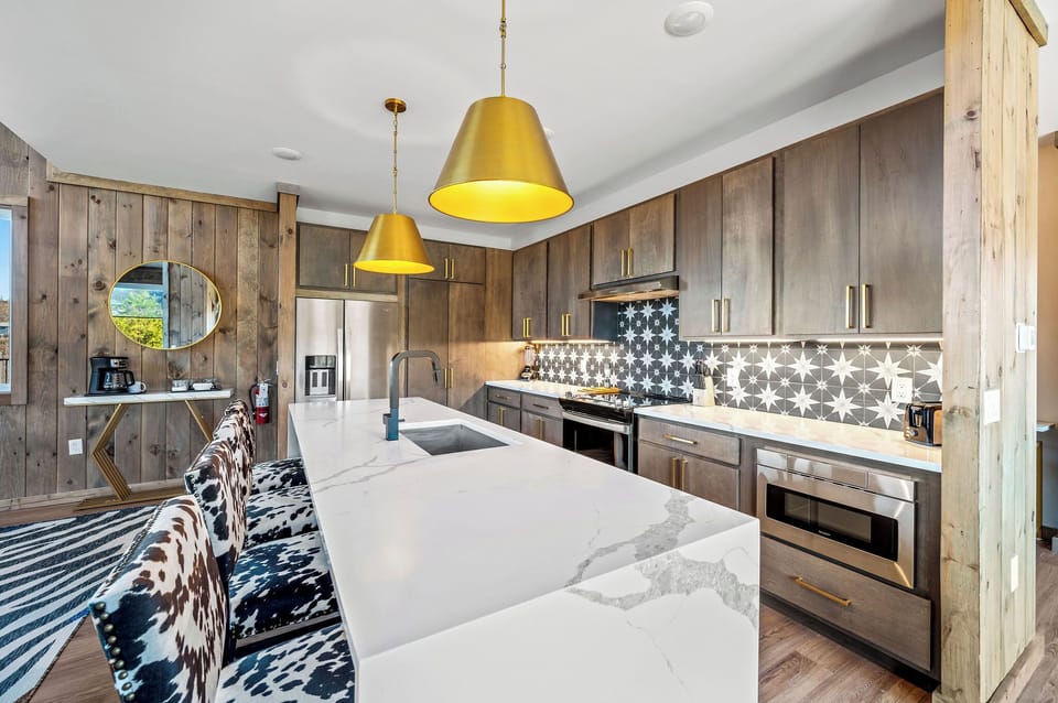 This gourmet kitchen blends rustic charm with sleek, modern design for feasts