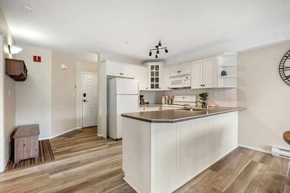 Full kitchen with a blender, drip coffee maker, ground coffee, tea, and sugar.