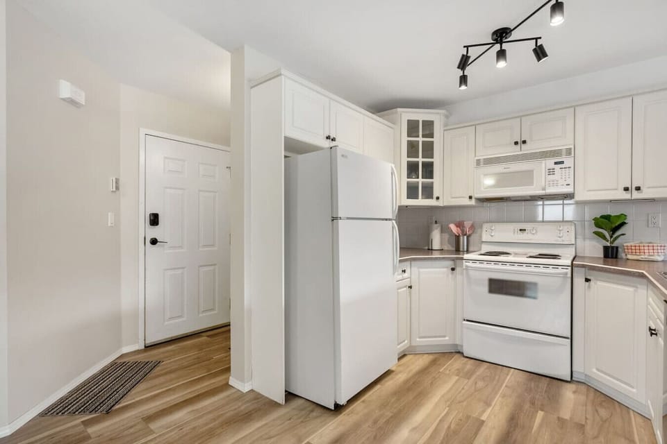 Full kitchen with a blender, drip coffee maker, ground coffee, tea, and sugar.