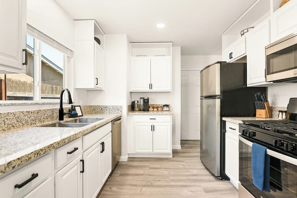 Fully stocked kitchen, with ample dishware, glassware, serving ware, pots & pans