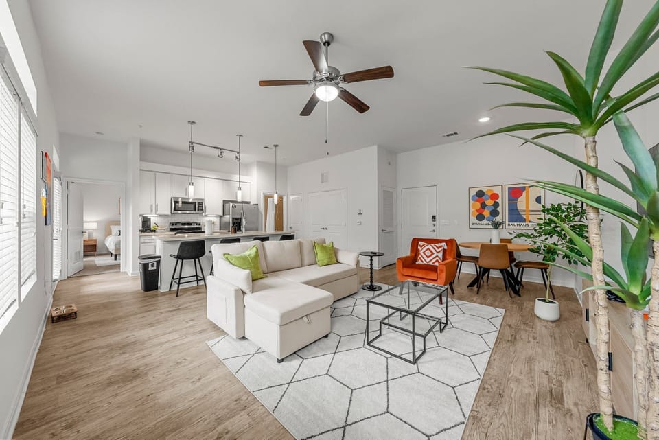 Modern living room features a sectional queen sized sofa bed, 65"smart TV & more