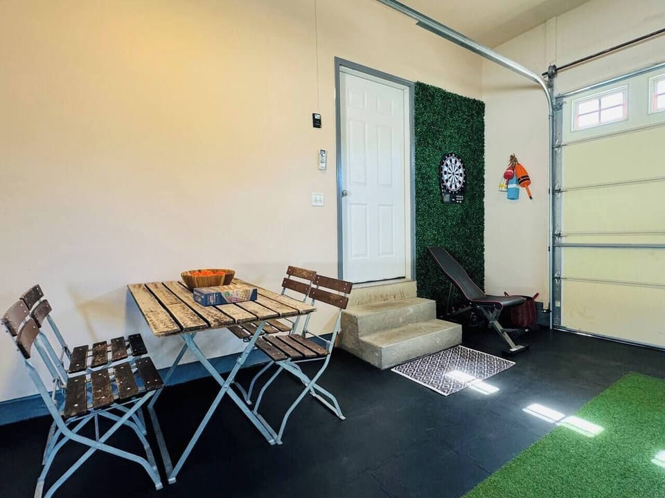 Enjoy this vibrant game room with activities like putting green, dartboard, cornhole, and ping pong. A colorful space for fun and relaxation with modern décor and seating!







