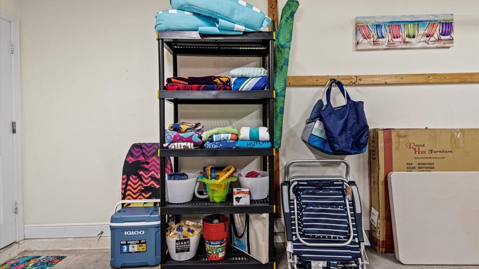 The garage is stocked with everything you need for a trip to the beach, including chairs,an  umbrella, towels, toys, a cooler, and more.
