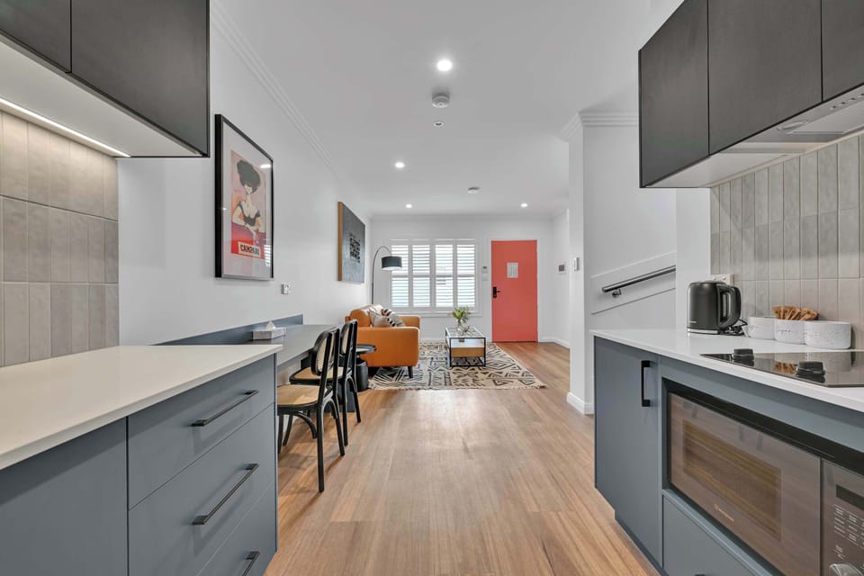 A convenient dining + work area adjoins the kitchen with provisions for laptop working, including multiple power outlets. Free WiFi is available throughout the unit.