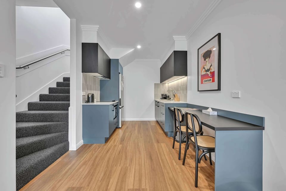 Convenient kitchen with combination microwave, fridge, kettle, toaster, and Nespresso coffee machine