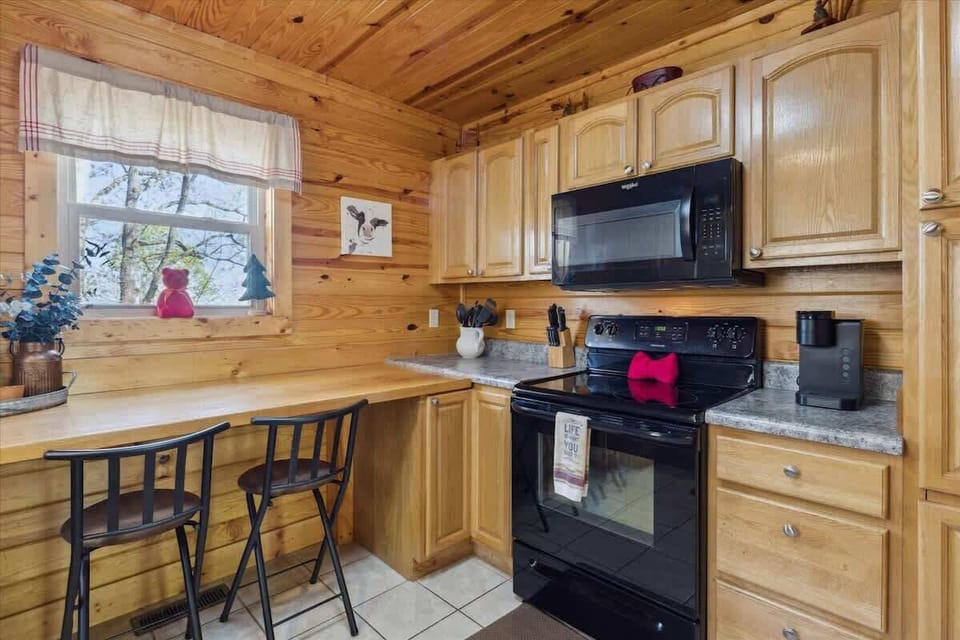 Whip up culinary delights in this charming, wood-paneled kitchen with scenic views!
