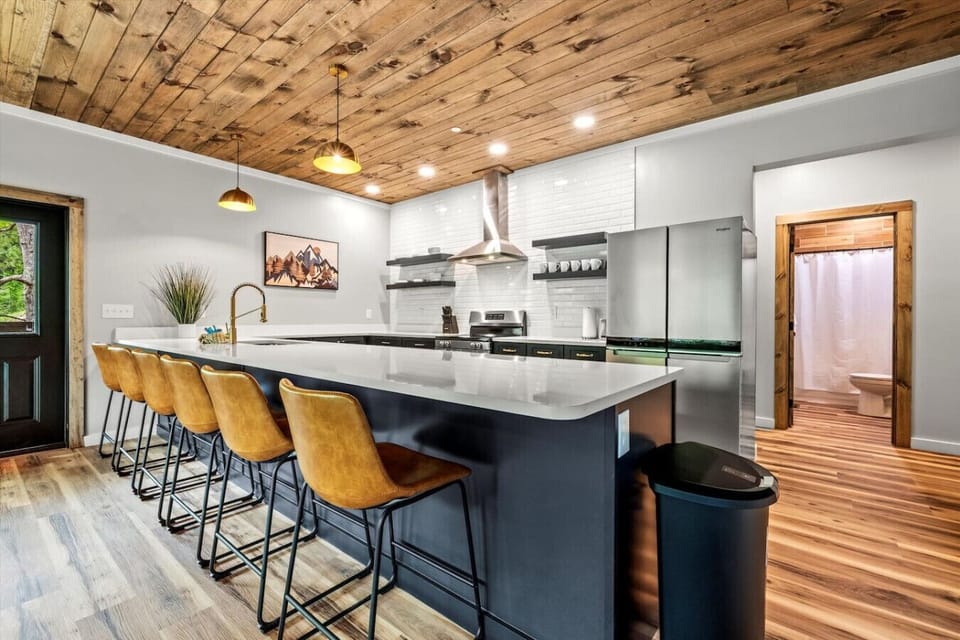 Pull up a stool and chat with the cook or gather for a late-night snack at the oversized island that anchors this inviting kitchen space.