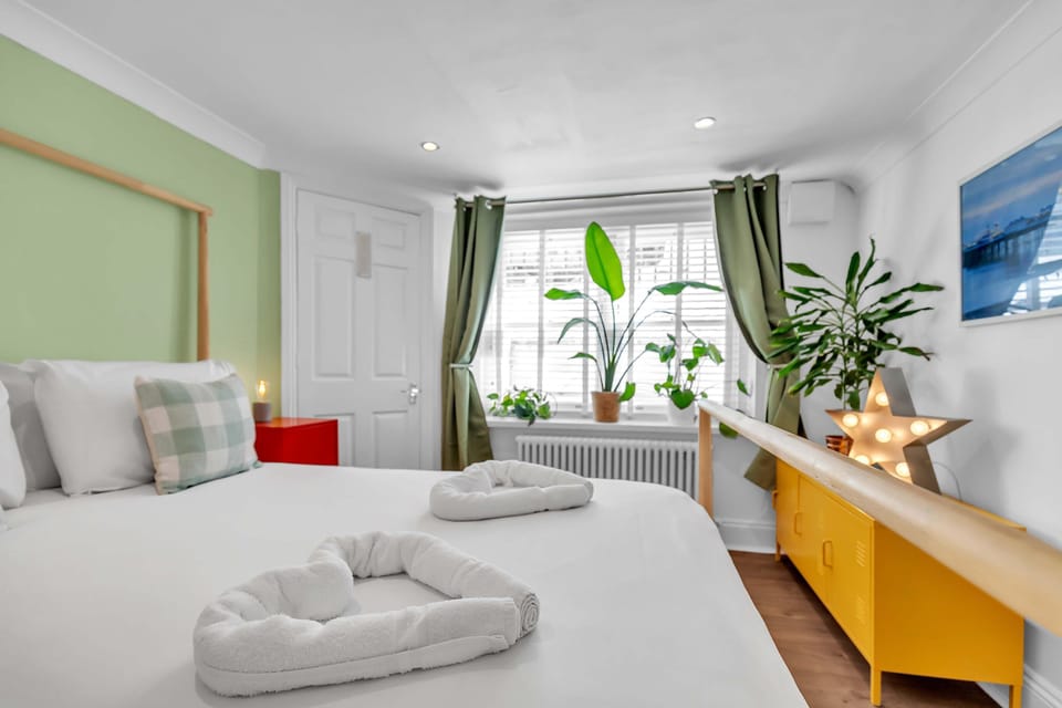 Master bedroom with double bed, feature lighting, and built-in wardrobes.