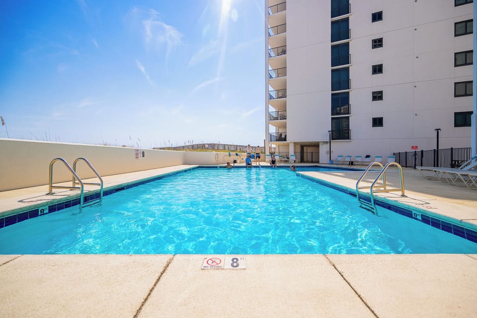 Take a refreshing dip in the pool to cool off after a beach day at Wind Drift