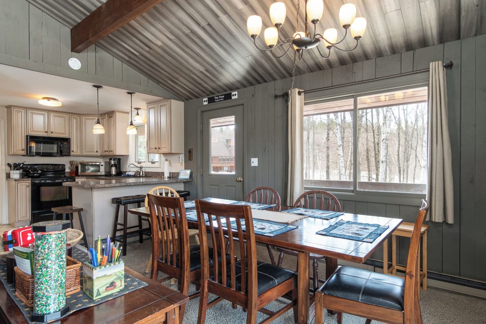 - Large dining table with seating for group meals and game nights   - Open concept with views of the kitchen for easy entertaining   - Perfect for family gatherings in a cozy Vermont retreat