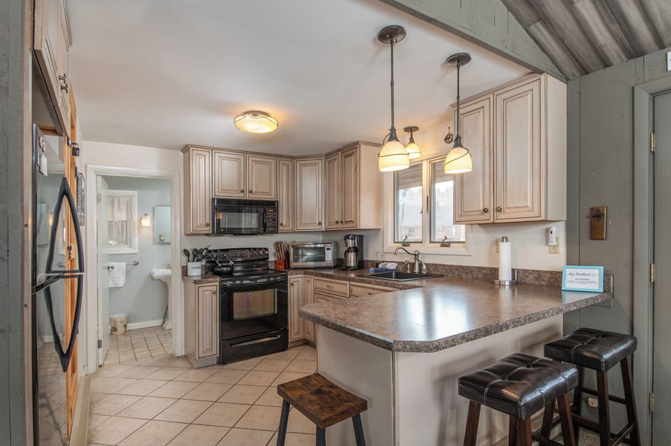 - Bright kitchen with modern appliances ready for cooking and gatherings   - Counter seating and open layout designed for family style dining   - Perfect for enjoying home cooked meals after mountain adventures