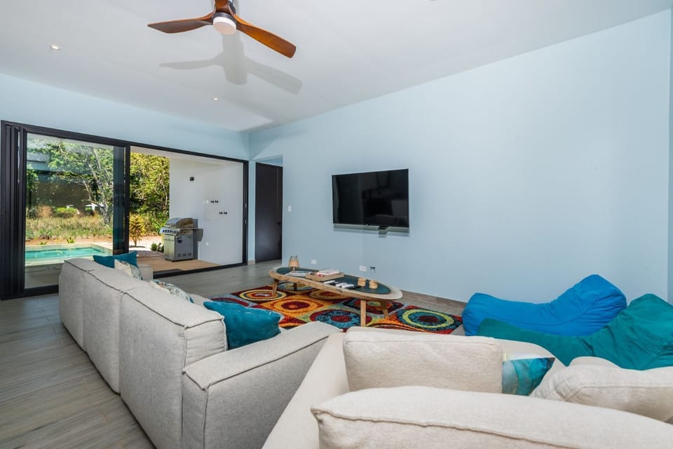 Living area with access to the BBQ and pool.