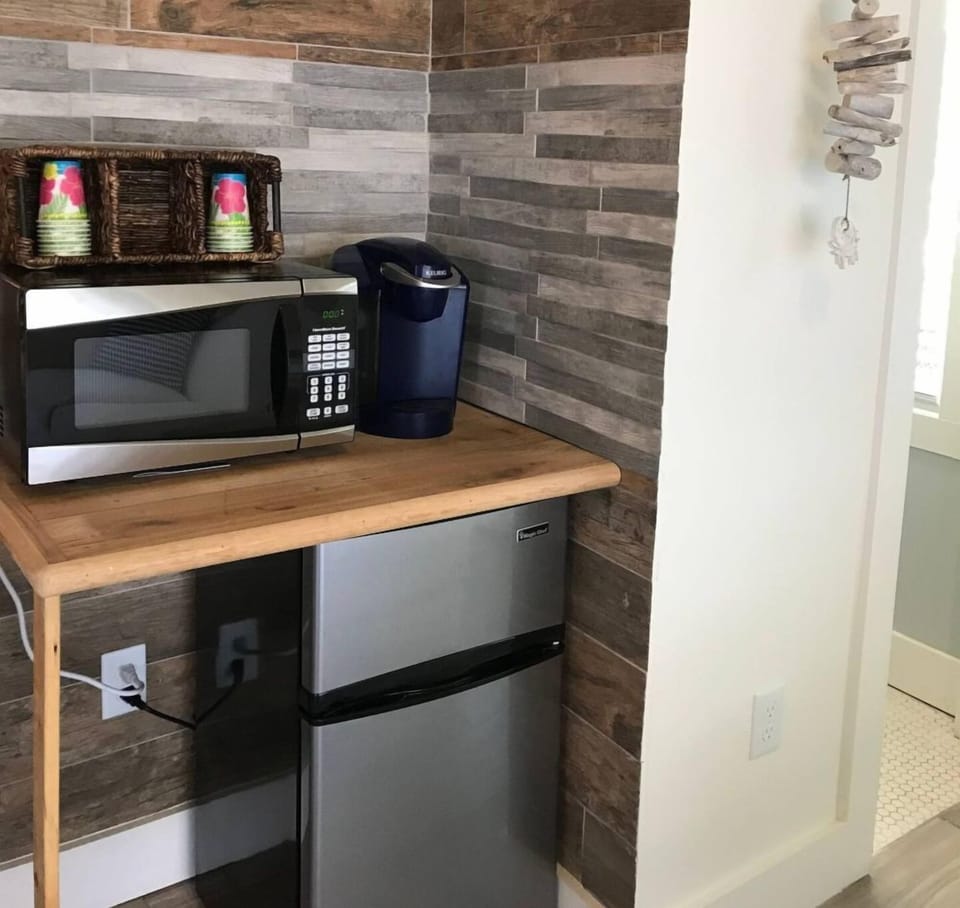 Microwave, Keurig coffee maker and small fridge.