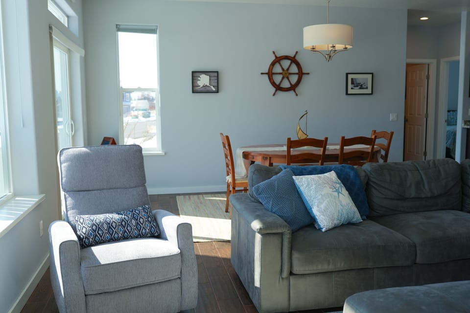 Cozy reading nook with natural light and peaceful Homer views.