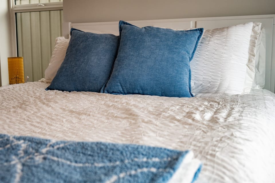 Each bedroom has plush linens and pillows.