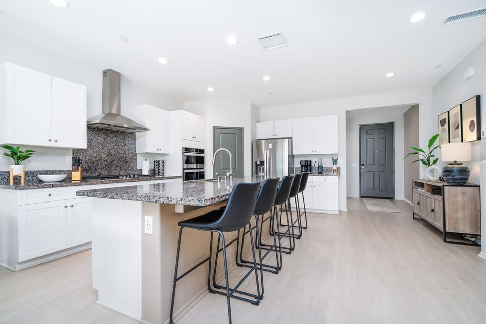 Fully equipped kitchen with modern stainless steel appliances.