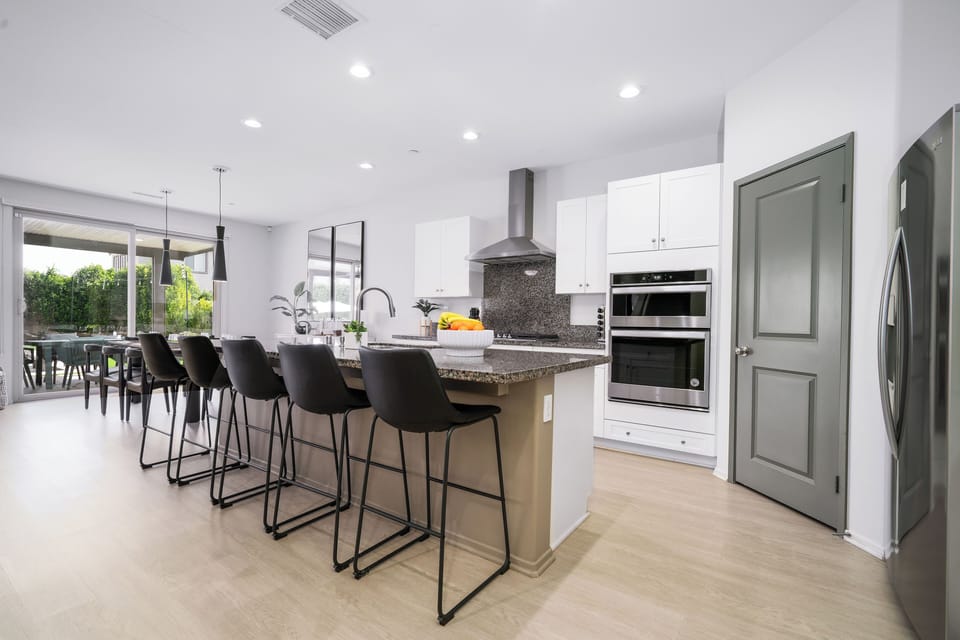 Fully equipped kitchen with modern stainless steel appliances.