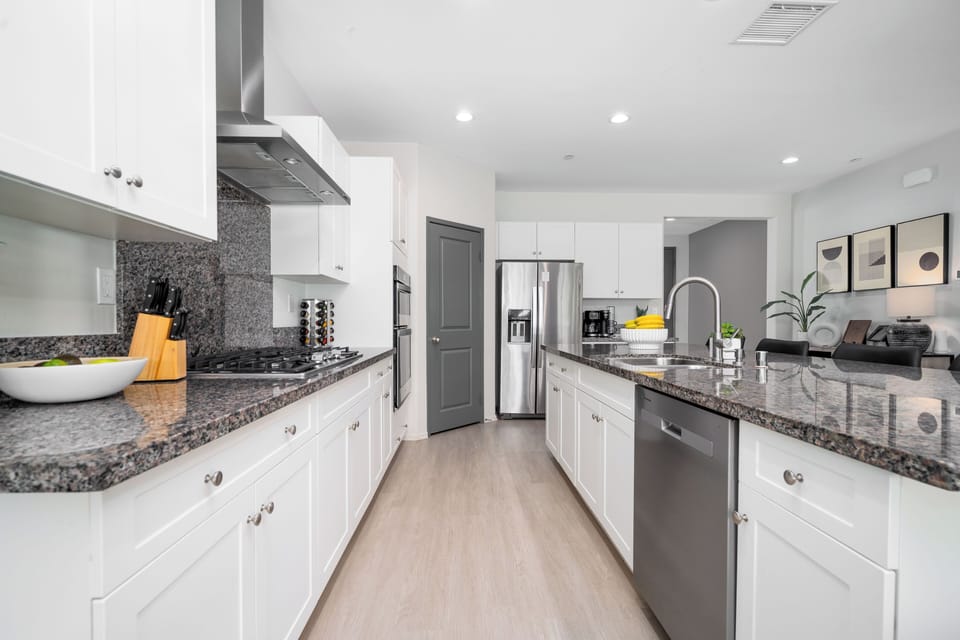 Fully equipped kitchen with modern stainless steel appliances.