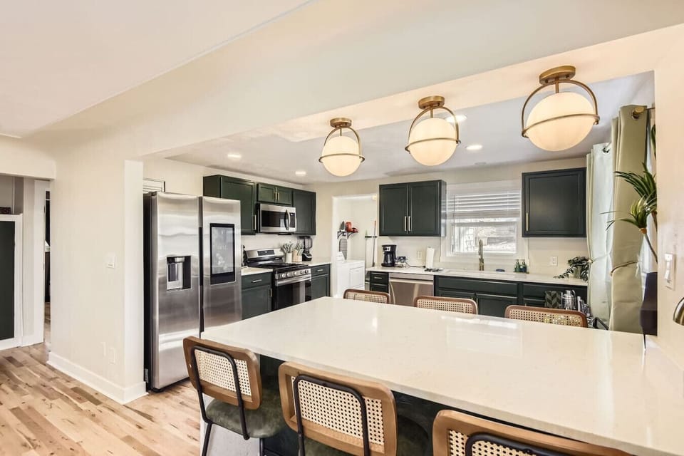Gather in the open concept, fully stocked kitchen with spacious bar seating for 6