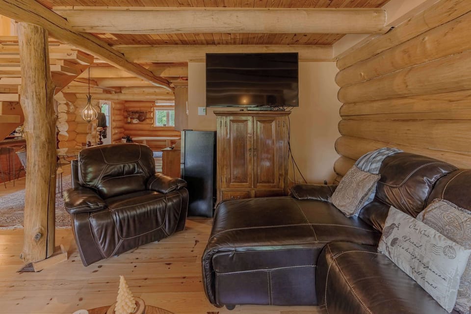 Relaxing TV area with recliners and log cabin wood accents