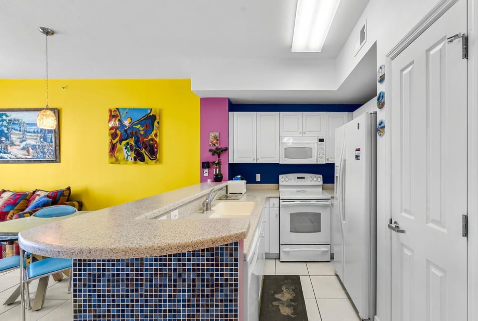Modern kitchen with colorful walls and a spacious countertop