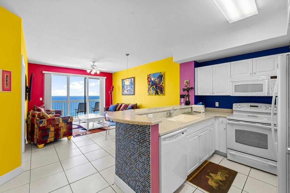 Colorful living area with ocean views and a modern kitchen.