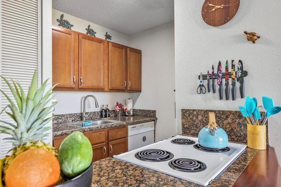Kitchen with all the comforts of home including full size fridge, stove/oven combo, and microwave.