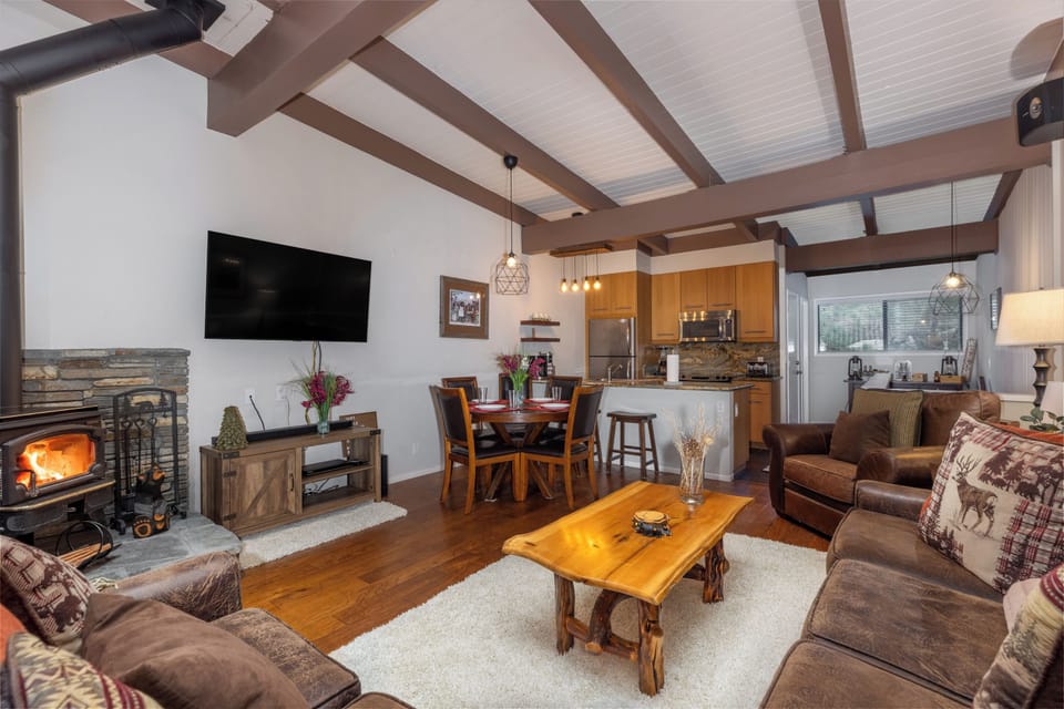 Spacious room with vaulted ceilings and an enticing fireplace