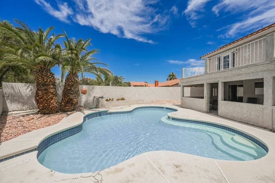 Sunny backyard with a private pool and comfortable seating.