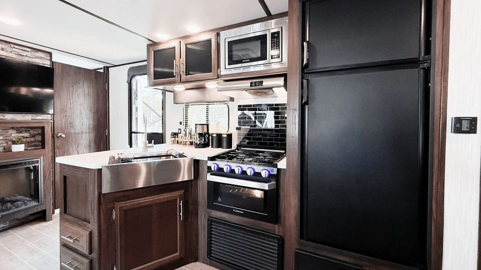 Kitchen has gas stove/oven, microwave, fridge/freezer, hood fan & large pantry.