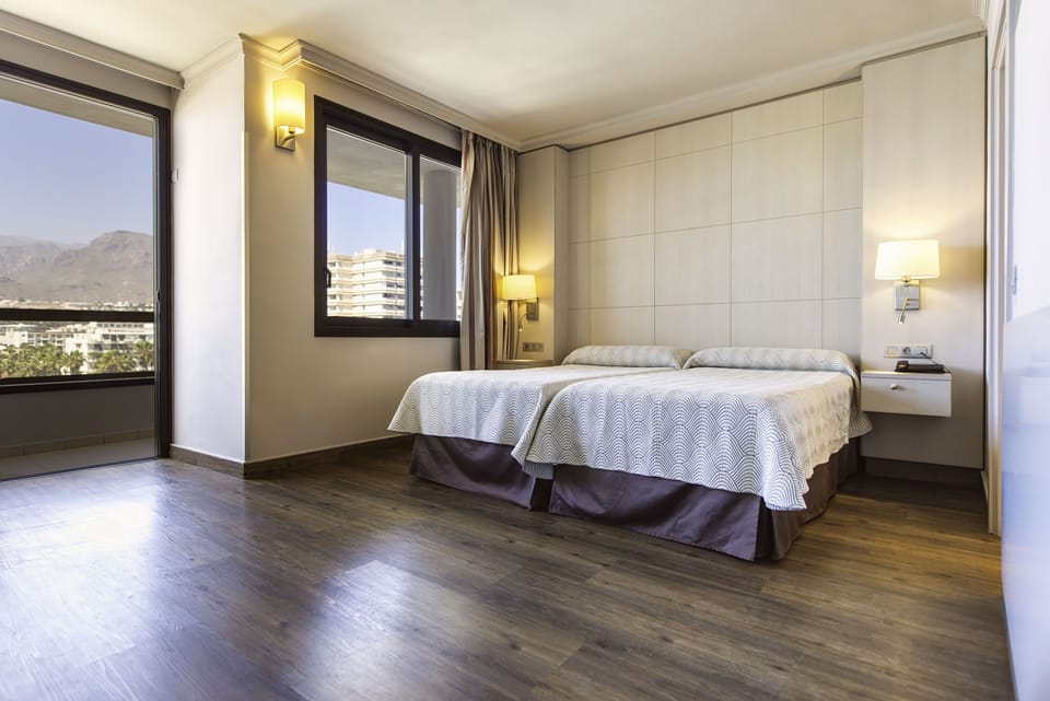 Double Room, Pool View | Minibar, in-room safe, desk, iron/ironing board