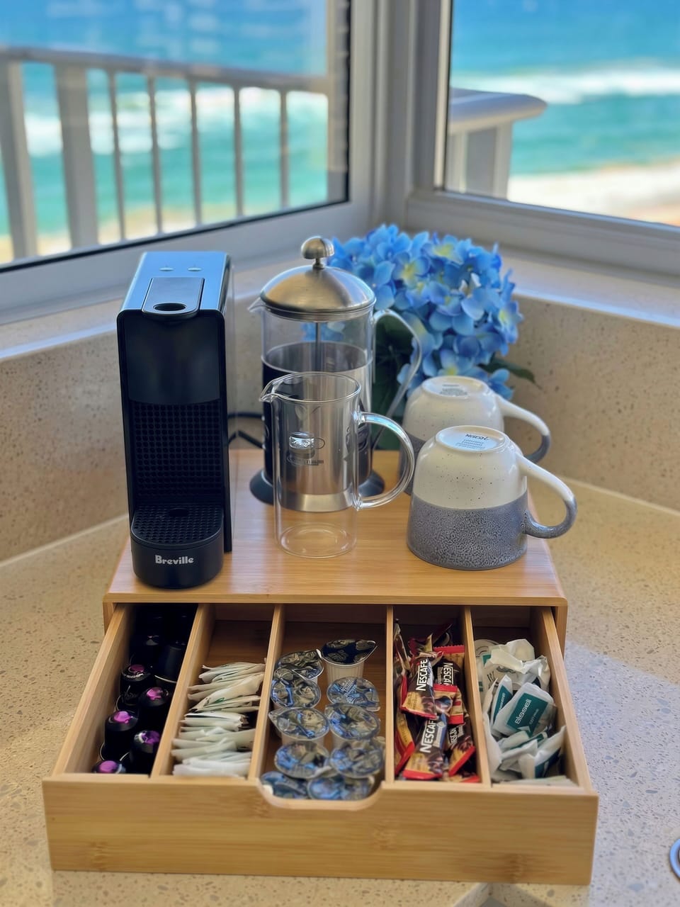 Coffee station with pod machine, tea selection and ocean views to start your day