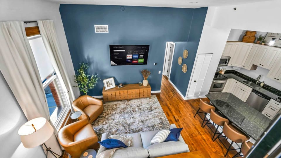 A stylish blend of leather, wood, and modern lines, this open-concept living room is made for connection and comfort. From above, you can truly appreciate the thoughtful layout and curated design touches that make this space shine.