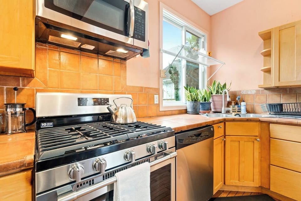 Fully equipped and filled with light, the kitchen opens to the backyard for easy outdoor dining.
