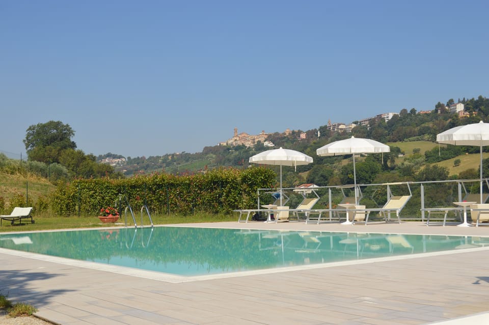 Seasonal outdoor pool, open 9:00 AM to 7:00 PM, pool umbrellas