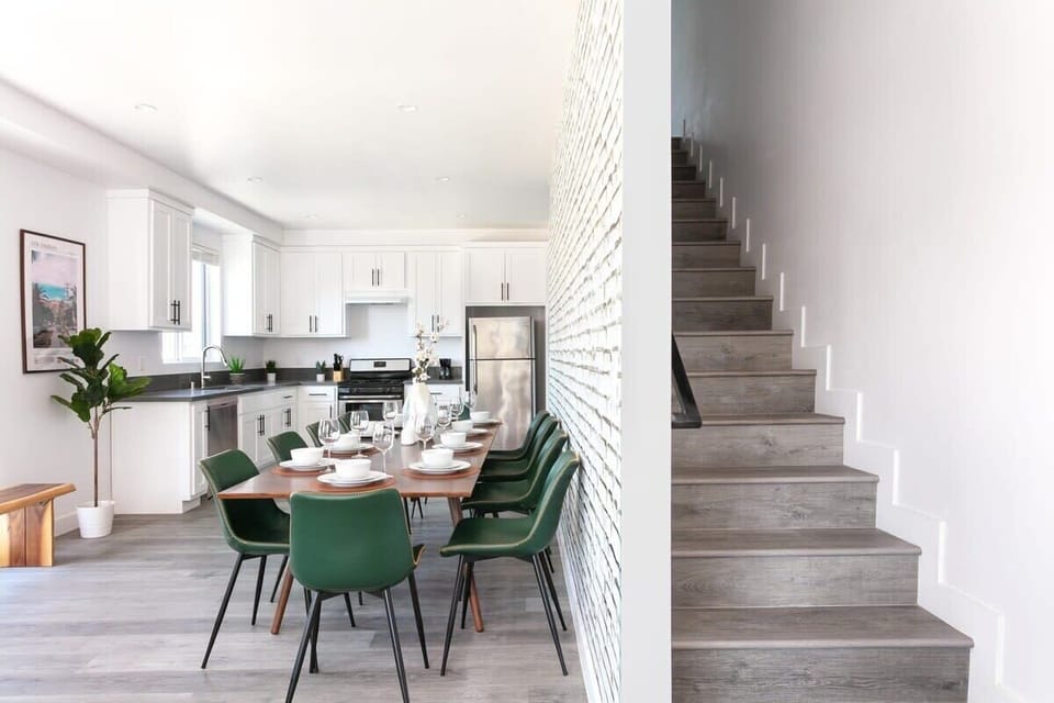 Open entryway with staircase and modern dining setup