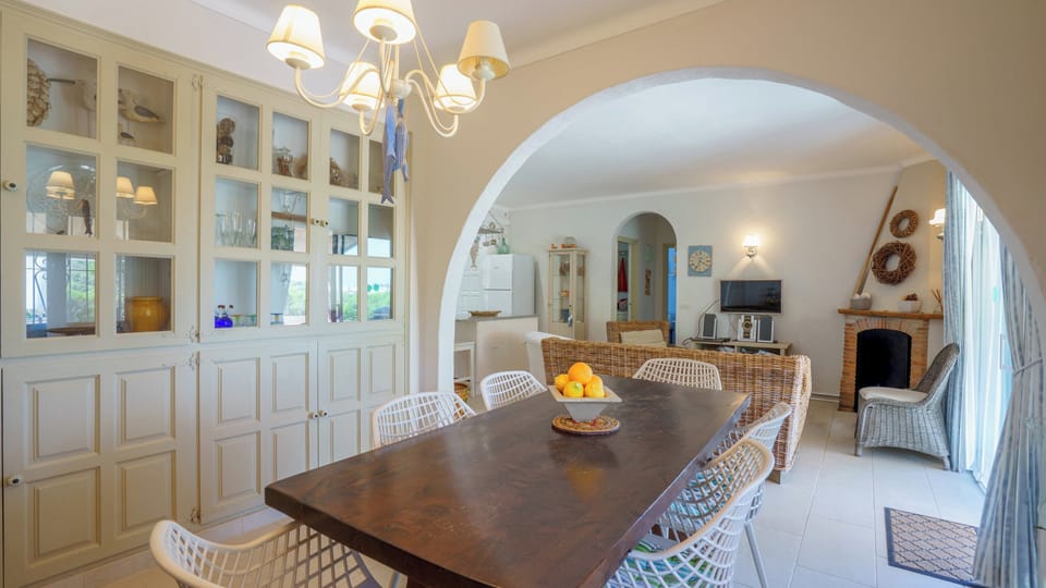 Why not share some family meals around the lovely wooden table? You'll just love the way the elegant dining space is connected to the cosy living area by a classic archway!