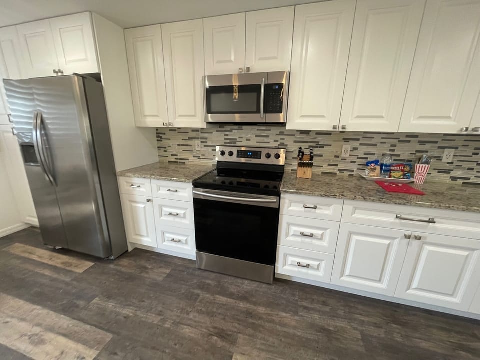 Stainless steel stove and refrigerator.