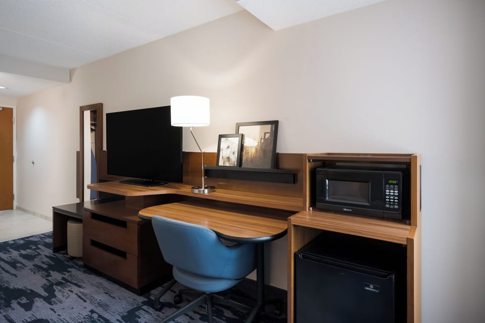 Premium bedding, desk, laptop workspace, blackout drapes