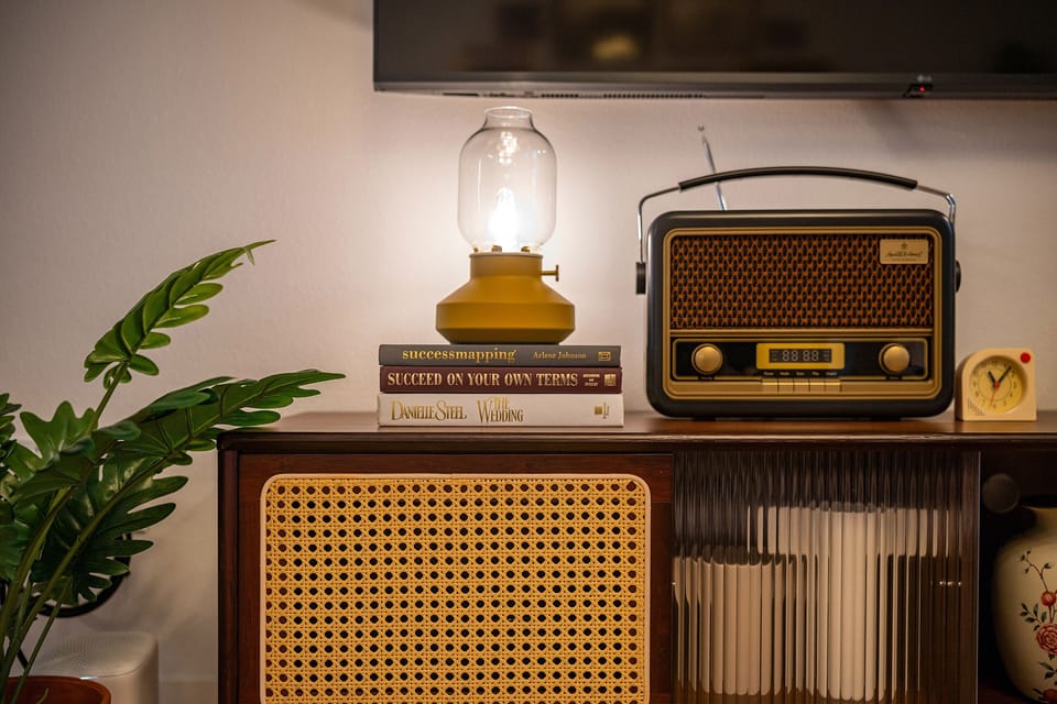 Vintage radio corner with curated records and decor.