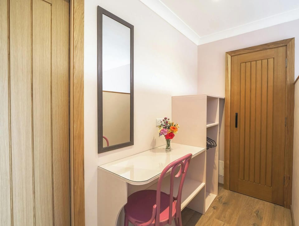 Dressing area with dressing table, mirror, chair and shelves