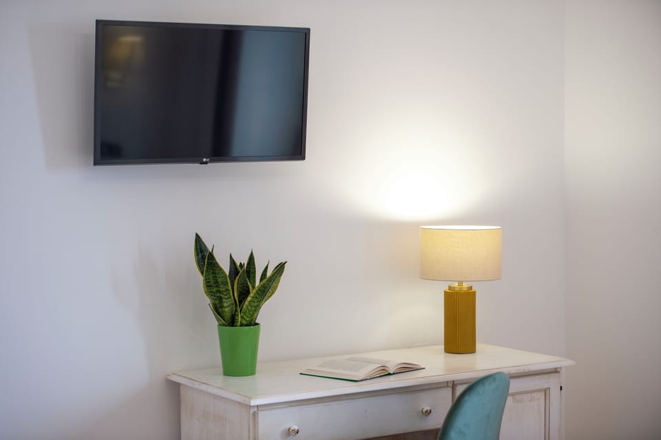 Deluxe Quadruple Room, Sea View | In-room safe, desk, laptop workspace, blackout drapes