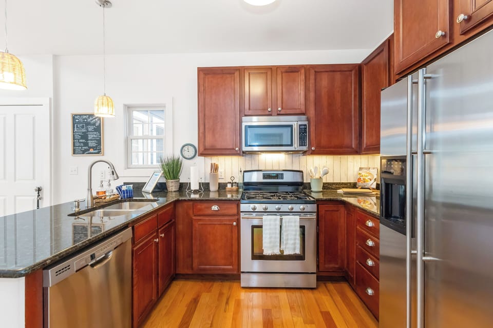 The kitchen offers great counter space, wood cabinets and stainless appliances.