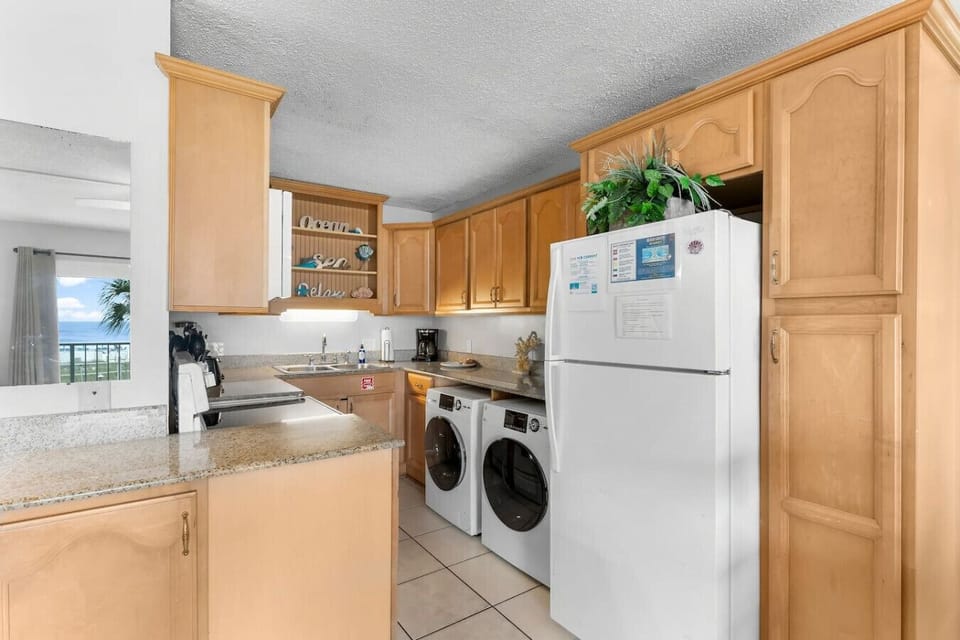 Kitchen with fridge, stove/oven, laundry