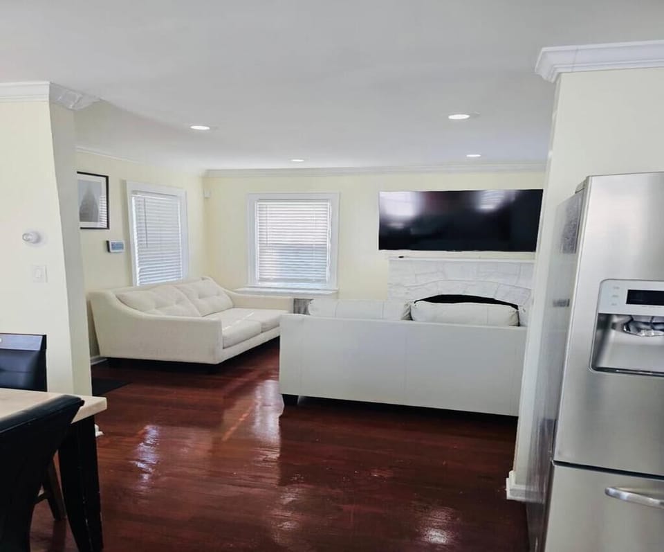 Cozy living room with comfy seating and smart TV — perfect for unwinding.